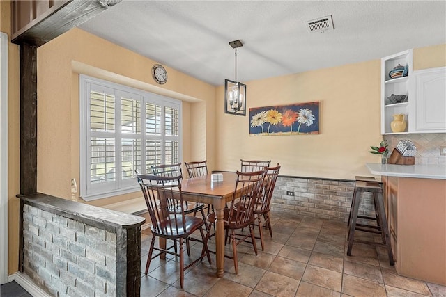 dining area with bar and a chandelier