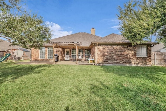 back of property with a playground, a pergola, a yard, and a patio