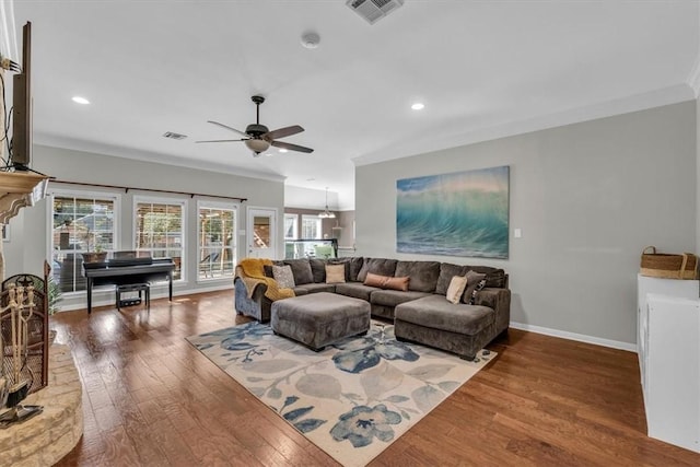 living room featuring ceiling fan, dark hardwood / wood-style flooring, and ornamental molding