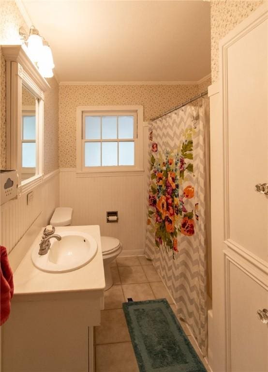 full bathroom featuring wainscoting, crown molding, vanity, and wallpapered walls