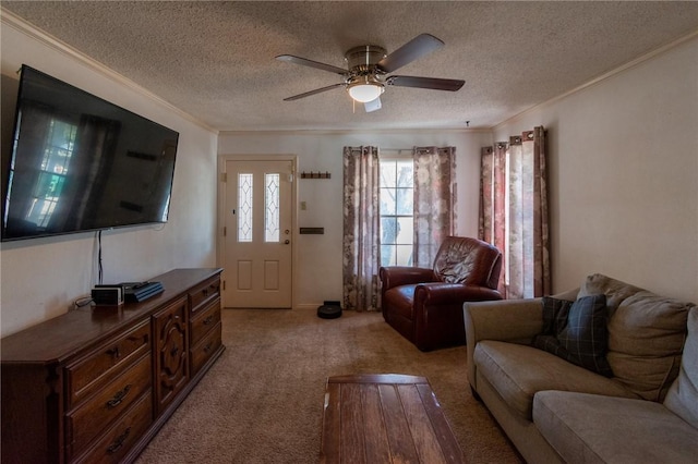 living room with light carpet, ceiling fan, ornamental molding, and a textured ceiling