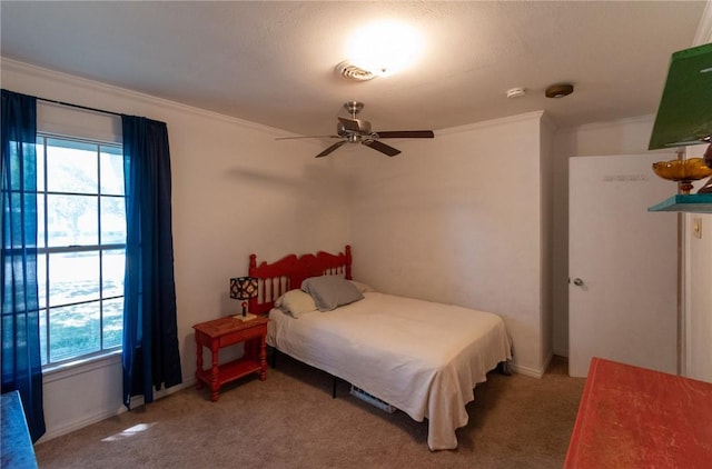 bedroom with ornamental molding, multiple windows, and carpet flooring