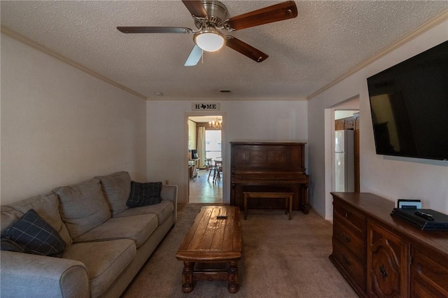 living room with light carpet, a textured ceiling, ceiling fan with notable chandelier, and crown molding