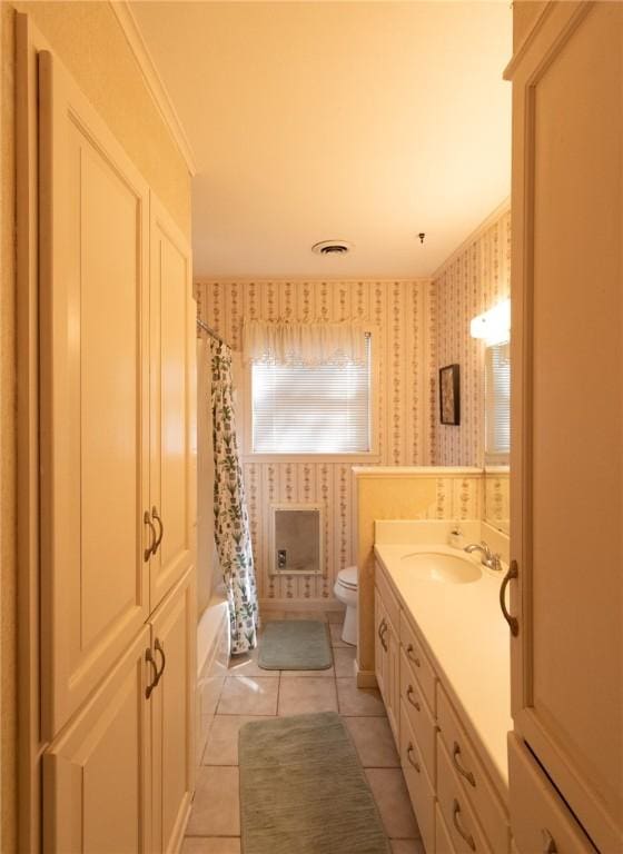 full bathroom with wallpapered walls, toilet, tile patterned floors, shower / bathtub combination with curtain, and vanity