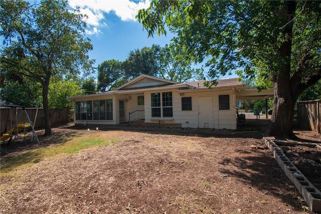 back of house with a fenced backyard and an attached carport