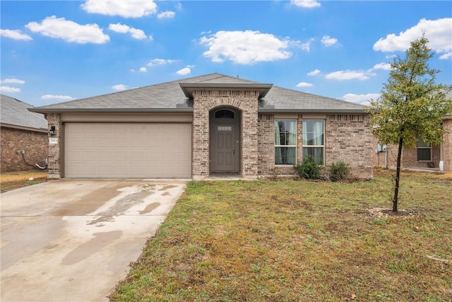 view of front of home with an attached garage, brick siding, a shingled roof, driveway, and a front lawn