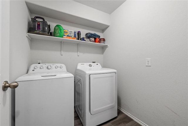 washroom featuring dark wood-style floors, washing machine and dryer, laundry area, and baseboards