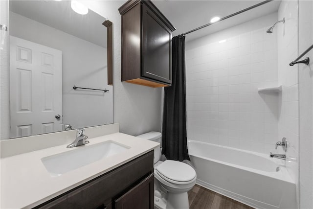 full bath featuring shower / tub combo with curtain, vanity, toilet, and wood finished floors