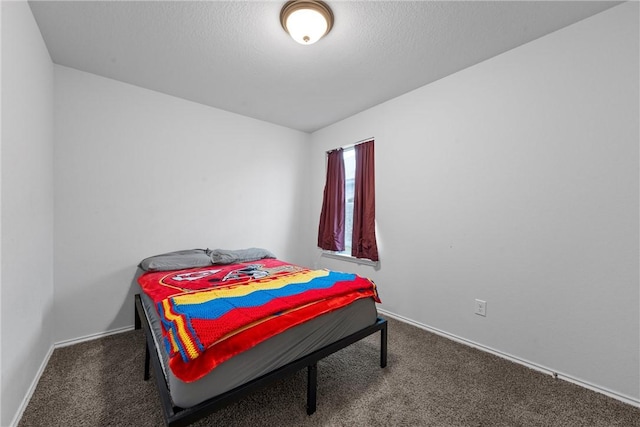 bedroom featuring carpet floors, a textured ceiling, and baseboards