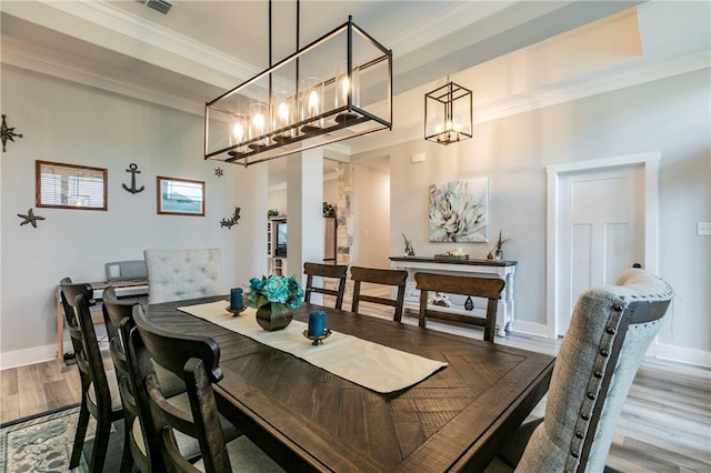 dining area with crown molding and wood-type flooring