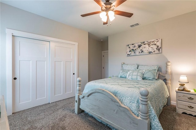 carpeted bedroom with ceiling fan and a closet