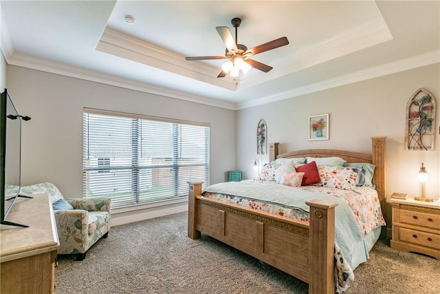 bedroom featuring ceiling fan, light colored carpet, ornamental molding, and a tray ceiling