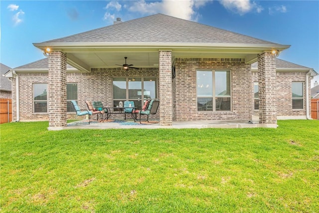 rear view of property with ceiling fan, an outdoor hangout area, a patio, and a yard