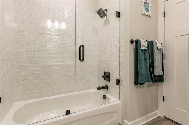 bathroom featuring combined bath / shower with glass door and wood-type flooring