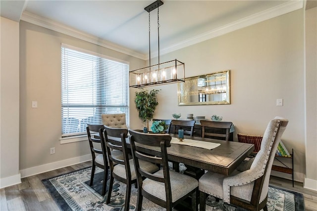 dining room with crown molding, a healthy amount of sunlight, and dark hardwood / wood-style floors