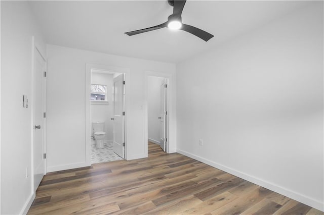 unfurnished bedroom featuring ceiling fan, dark hardwood / wood-style flooring, and ensuite bathroom