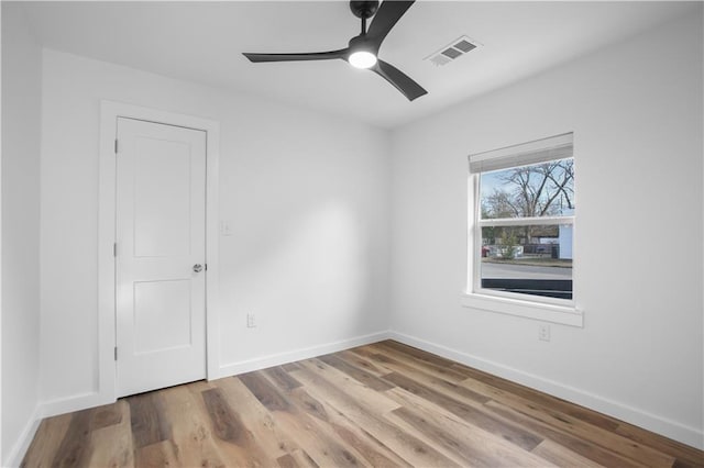 spare room with ceiling fan and wood-type flooring