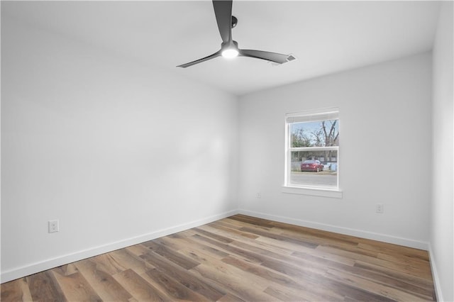 spare room featuring ceiling fan and hardwood / wood-style floors