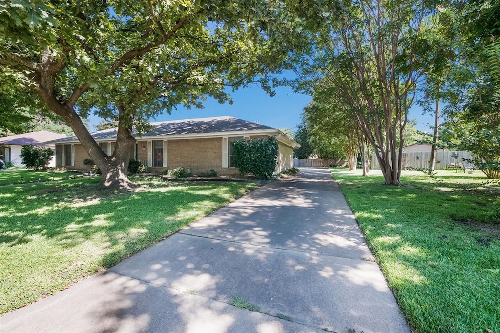 ranch-style home with a front lawn