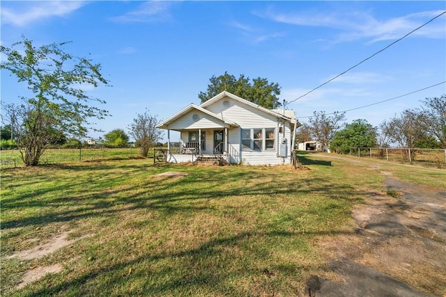 view of front of home with a porch and a front lawn