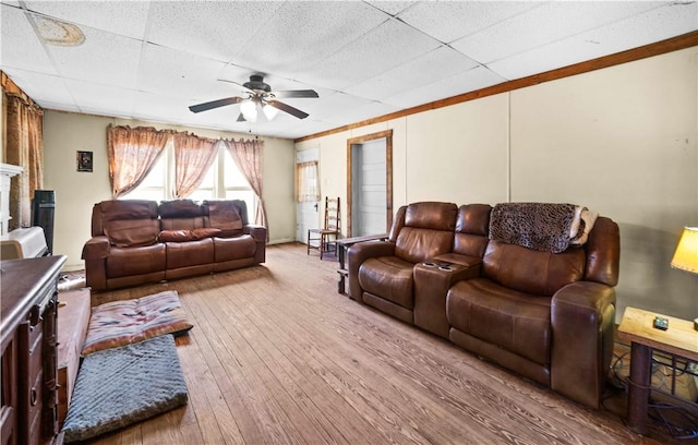 living room featuring ceiling fan, hardwood / wood-style floors, and a drop ceiling