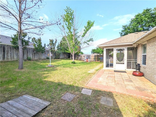 view of yard featuring a patio area and a sunroom