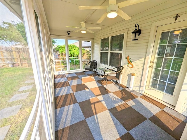 sunroom featuring ceiling fan