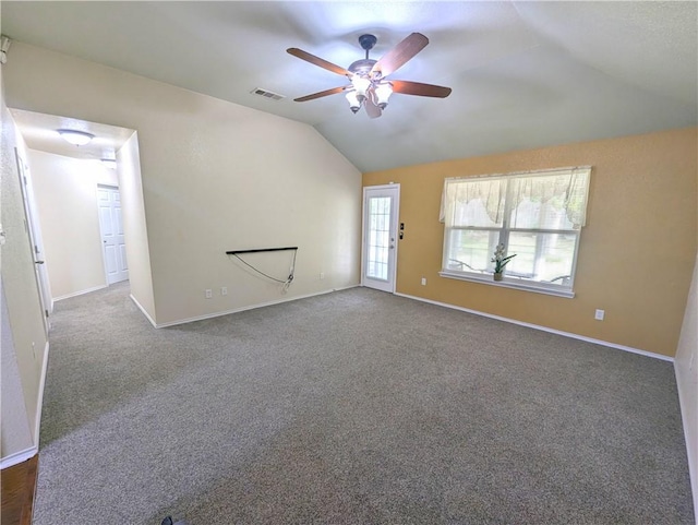 unfurnished living room featuring ceiling fan, lofted ceiling, and dark colored carpet