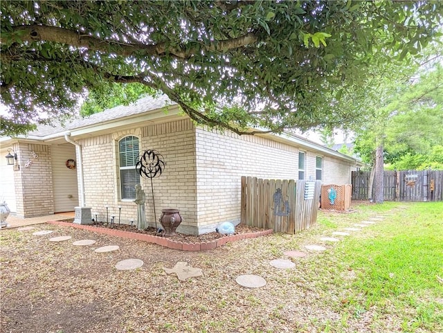 view of side of home featuring a yard