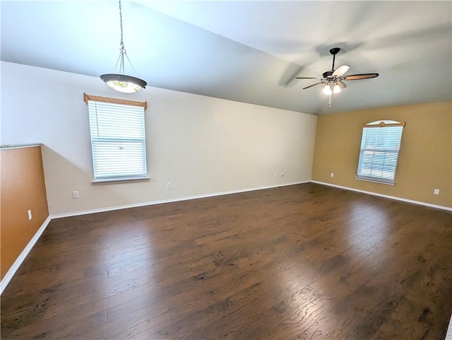 spare room with vaulted ceiling, ceiling fan, plenty of natural light, and dark hardwood / wood-style floors