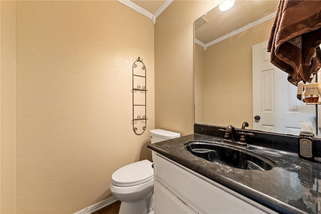 bathroom featuring vanity, toilet, and crown molding