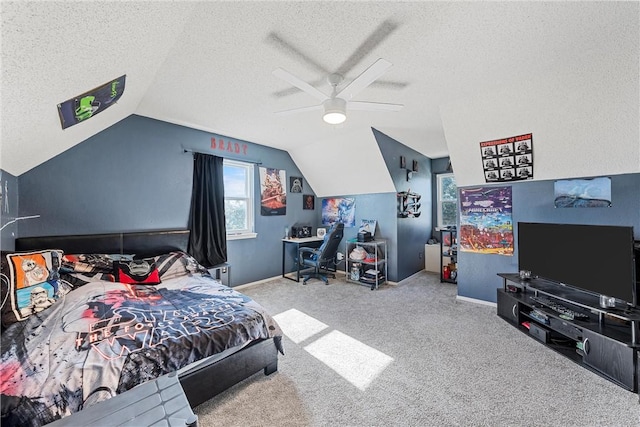 carpeted bedroom with a textured ceiling, vaulted ceiling, and ceiling fan