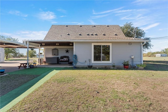 back of house featuring a patio and a lawn