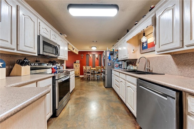 kitchen featuring white cabinetry, sink, and appliances with stainless steel finishes