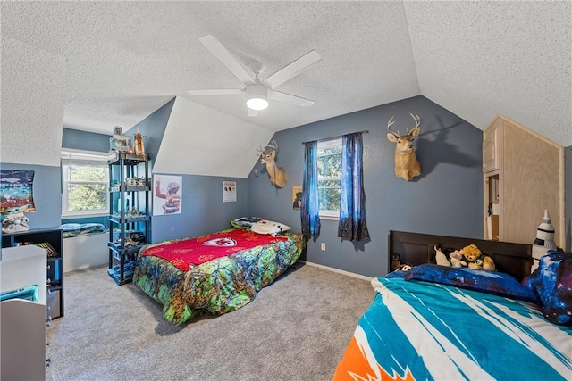 bedroom featuring a textured ceiling, ceiling fan, light carpet, and multiple windows