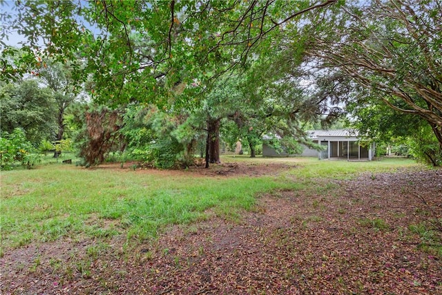 view of yard featuring a sunroom