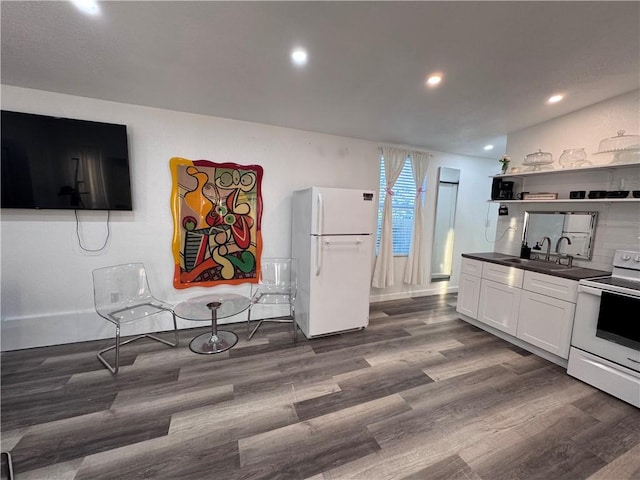 kitchen with white cabinets, white appliances, dark wood-type flooring, and sink