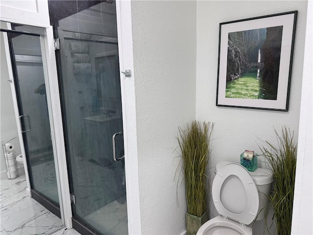 bathroom with an enclosed shower and toilet