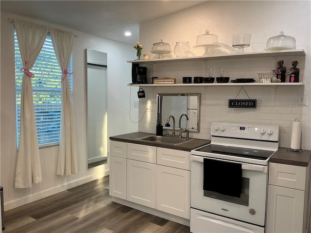 kitchen with sink, white cabinets, dark wood-type flooring, and white appliances