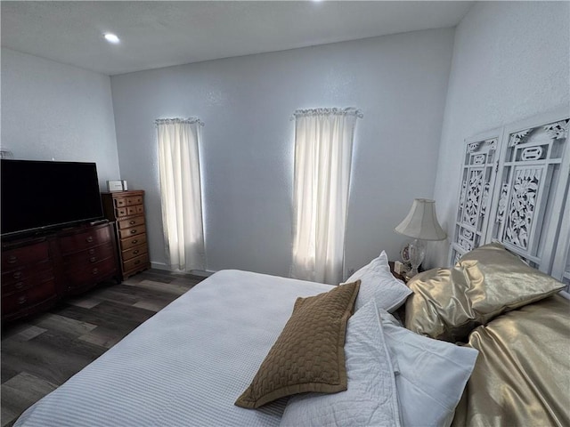 bedroom with dark hardwood / wood-style floors