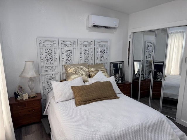 bedroom with a wall mounted air conditioner, dark hardwood / wood-style floors, and a closet