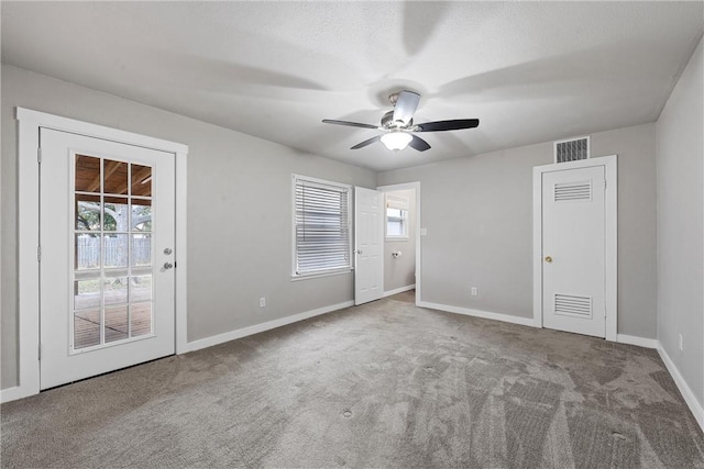 carpeted spare room with ceiling fan