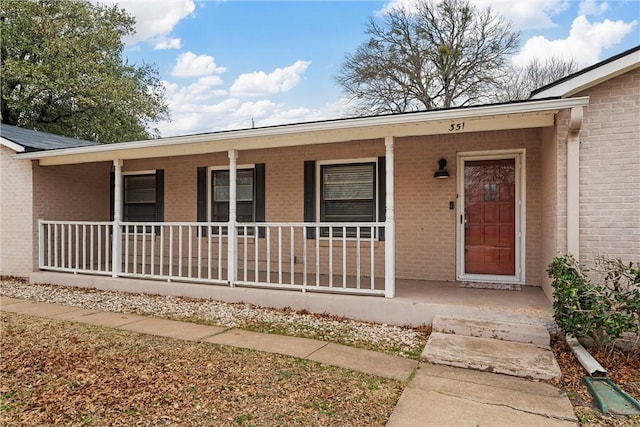 view of exterior entry with covered porch