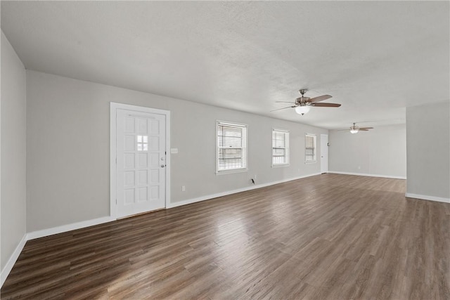 unfurnished living room with hardwood / wood-style flooring, ceiling fan, and a textured ceiling