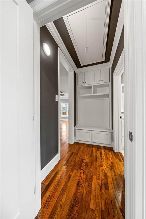 hallway featuring dark hardwood / wood-style floors and ornamental molding