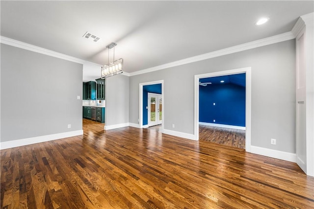 unfurnished living room featuring a chandelier, dark hardwood / wood-style floors, ornamental molding, and sink