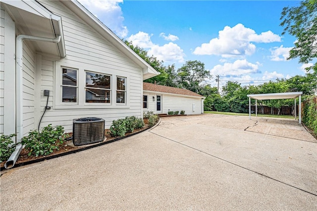 view of patio / terrace with a carport and central air condition unit