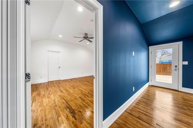 entrance foyer featuring hardwood / wood-style floors, ceiling fan, and lofted ceiling