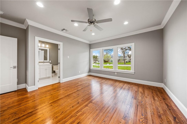 unfurnished bedroom with hardwood / wood-style floors, ceiling fan, crown molding, and ensuite bath