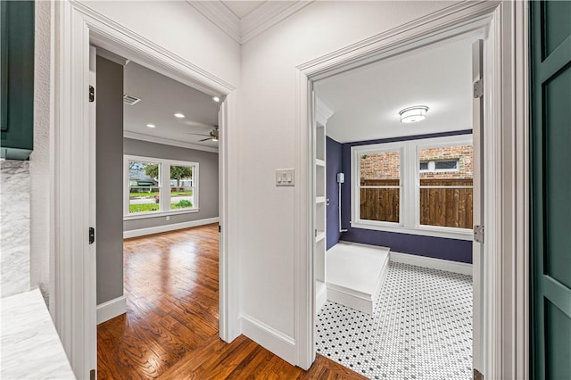 corridor with hardwood / wood-style flooring and ornamental molding